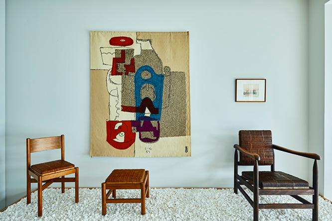 家具は坂倉準三が1940年代にデザインしたもの。壁のタピスリーは、1955年の「ル・コルビュジエ・レジェ・ペリアン 三人展」で実際に展示されたル・コルビュジエによる《二本の瓶と付属品》。