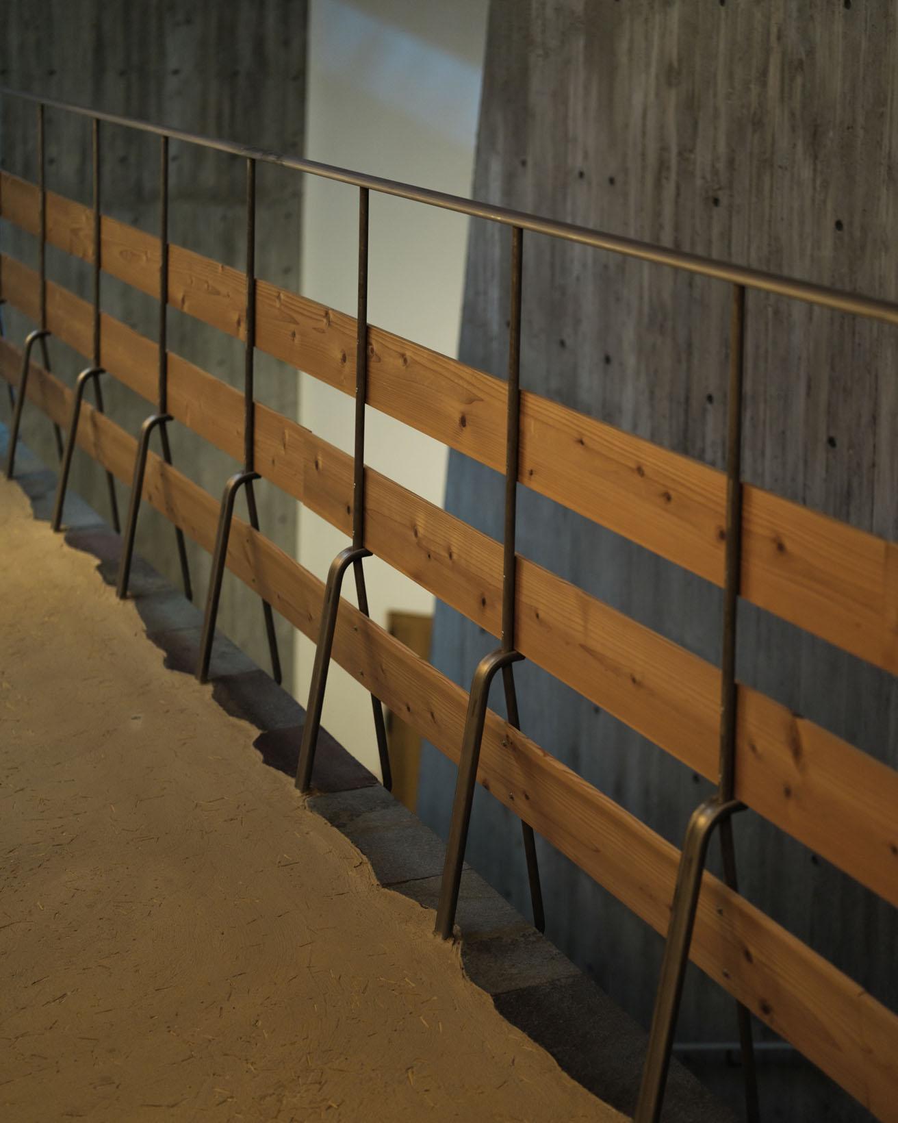 2階の市民ギャラリー前の柵や階段の手すりには、 丸棒を半分にした鋼材と杉板を合わせて使用。