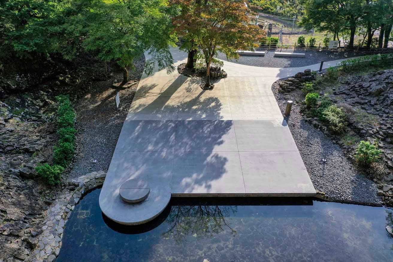 〈玄武洞公園〉 目の前の洞を見上げるように自然と対峙するコンクリート製のベンチなどを設置。人工物に曲線と直線を多用することで、有機的な自然とのコントラストをつけたという。